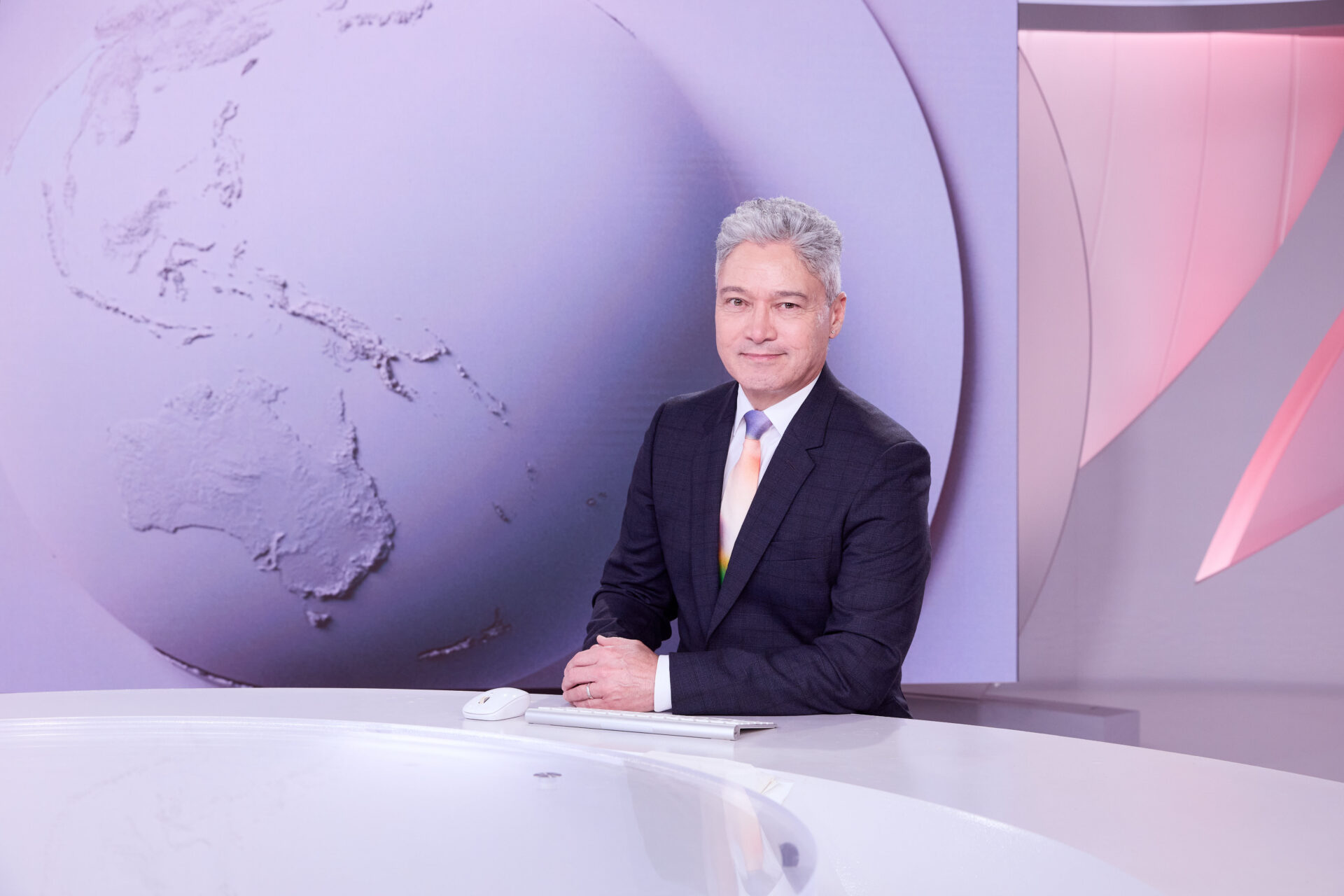 Anton Enus at desk - SBS World News